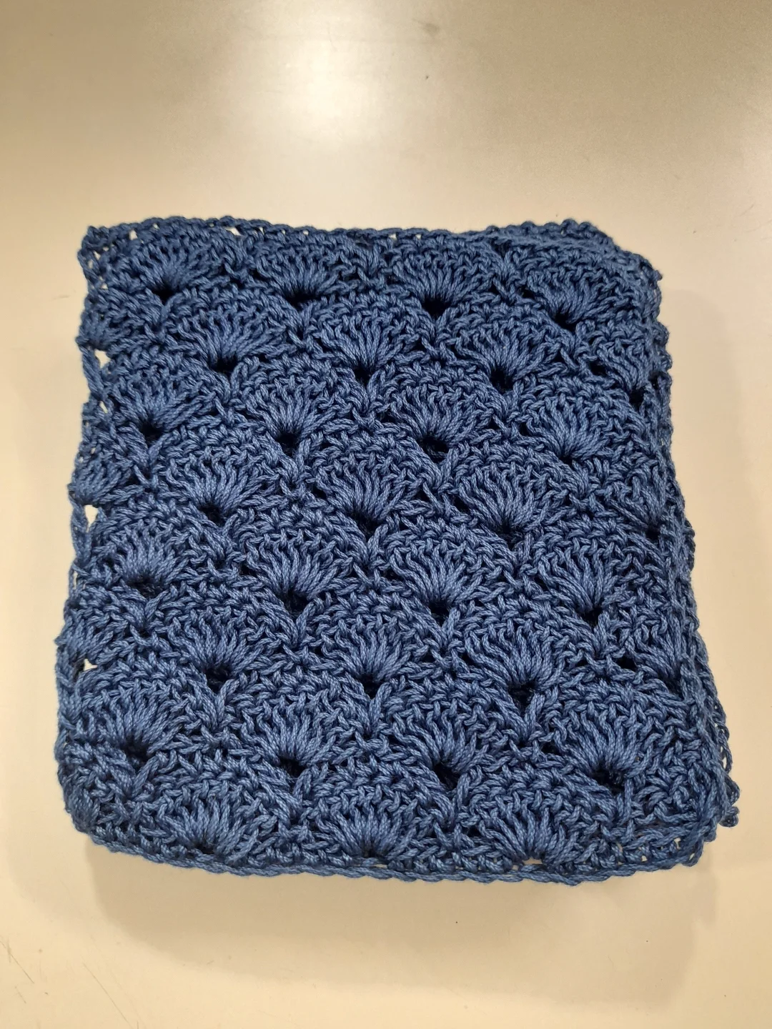 A close view of blue shell stitch, each fan overlapping the row below.