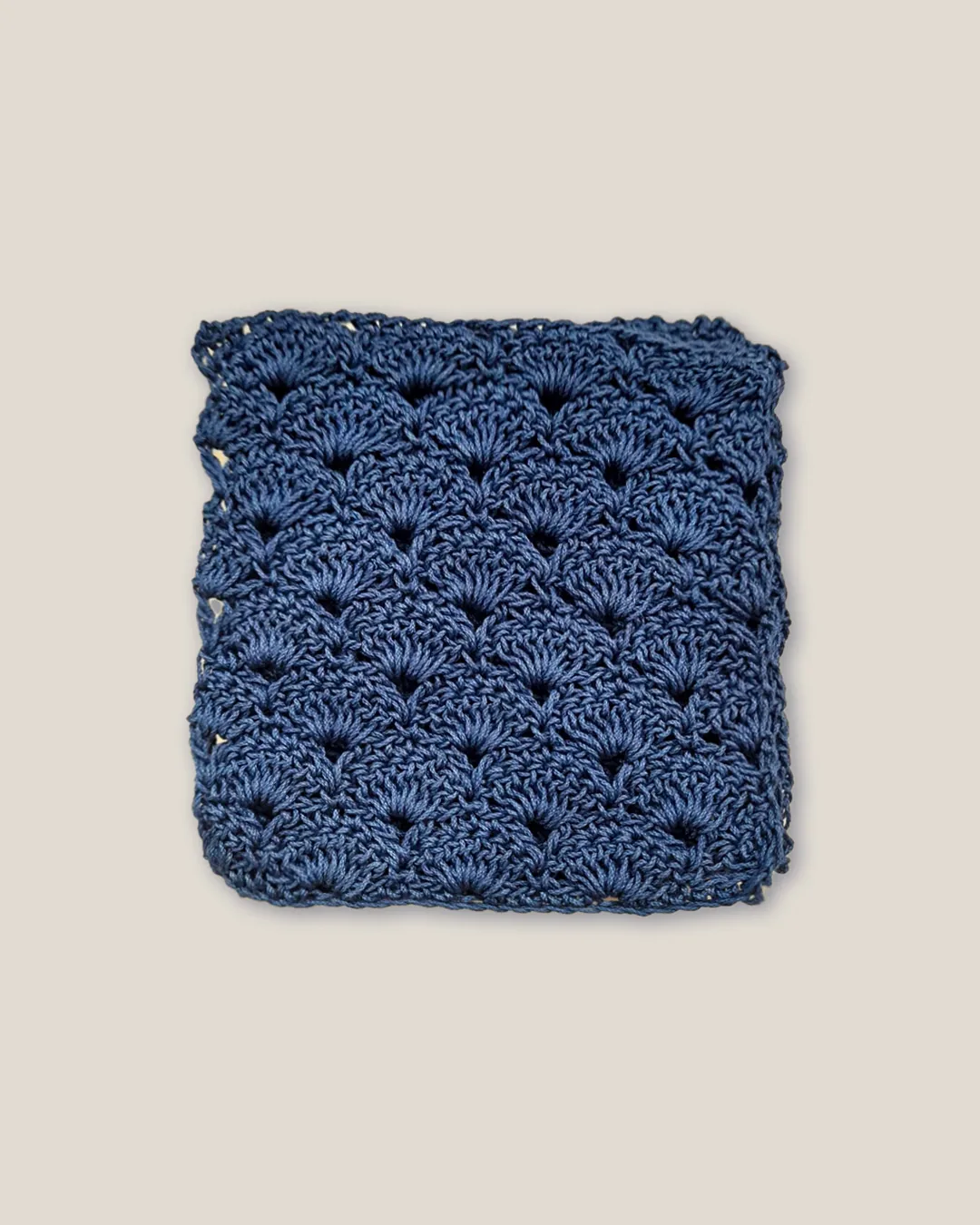 A square of blue shell stitch, each fan overlapping the row below.